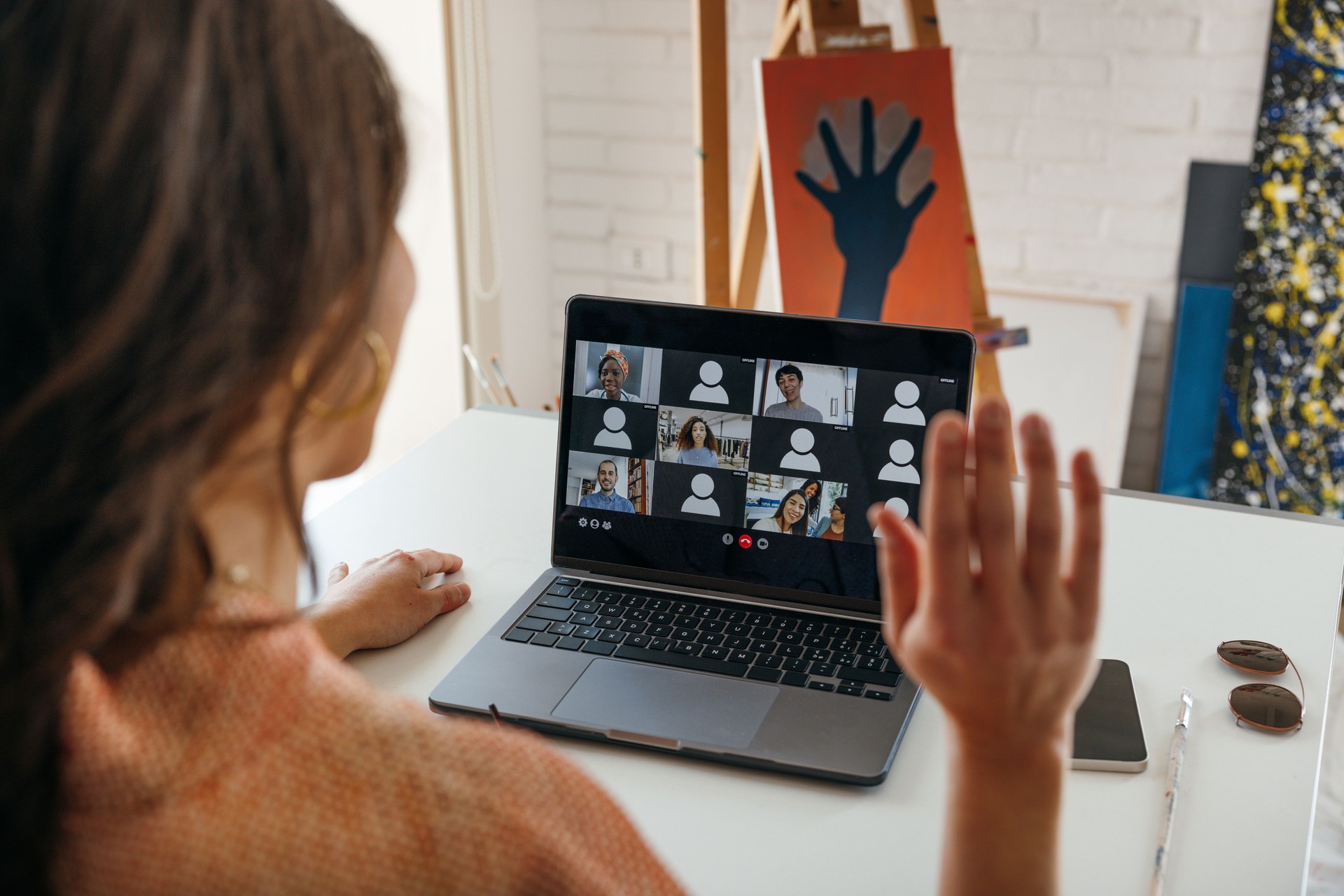 Artist painter taking painting class in video conference call from home